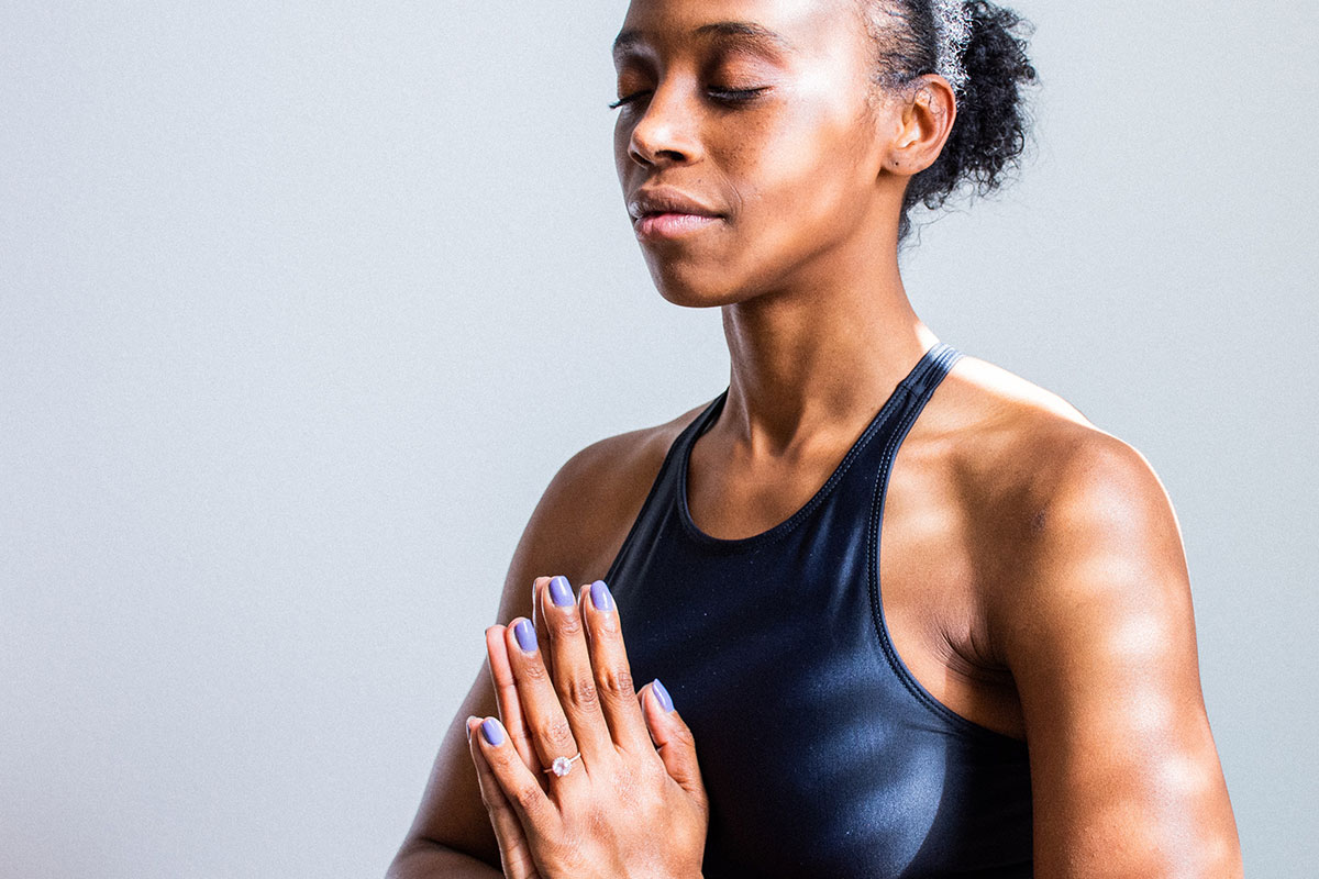 woman practicing yoga with hands in prayer position