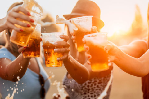 women clinking beer glasses