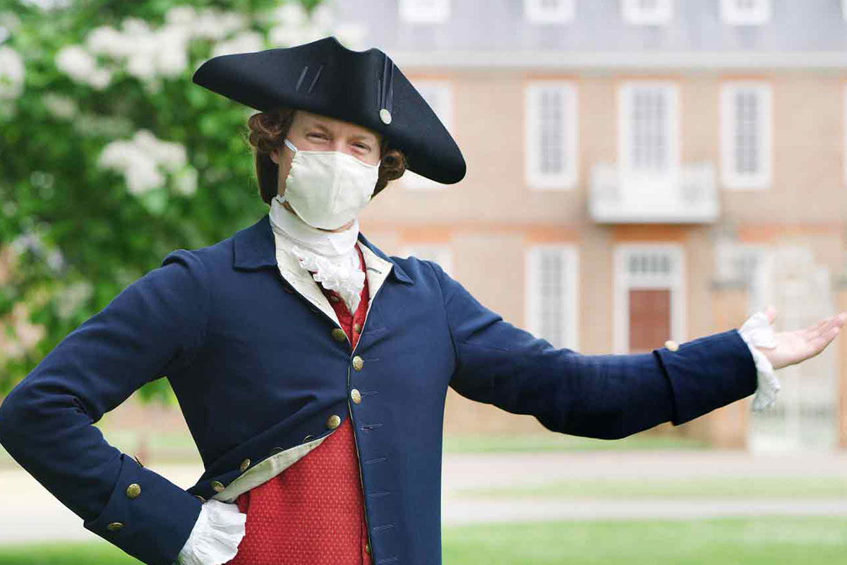 man in colonial garb with mask