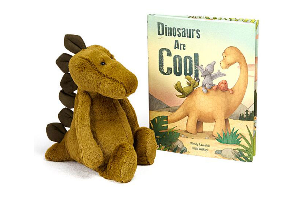 dinosaur stuffed animal next to book
