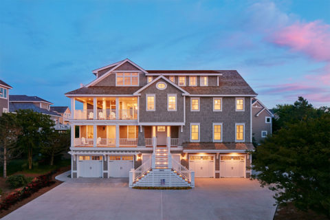 large house at nighttime with lights on