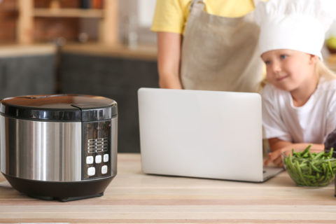 little girl with chef hat at computer