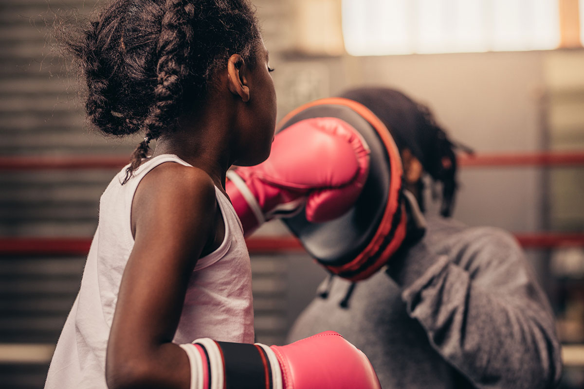 little girl with red gloves boxing