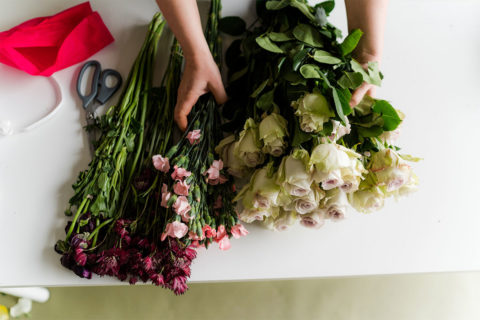 flowers being put together into a bouquet