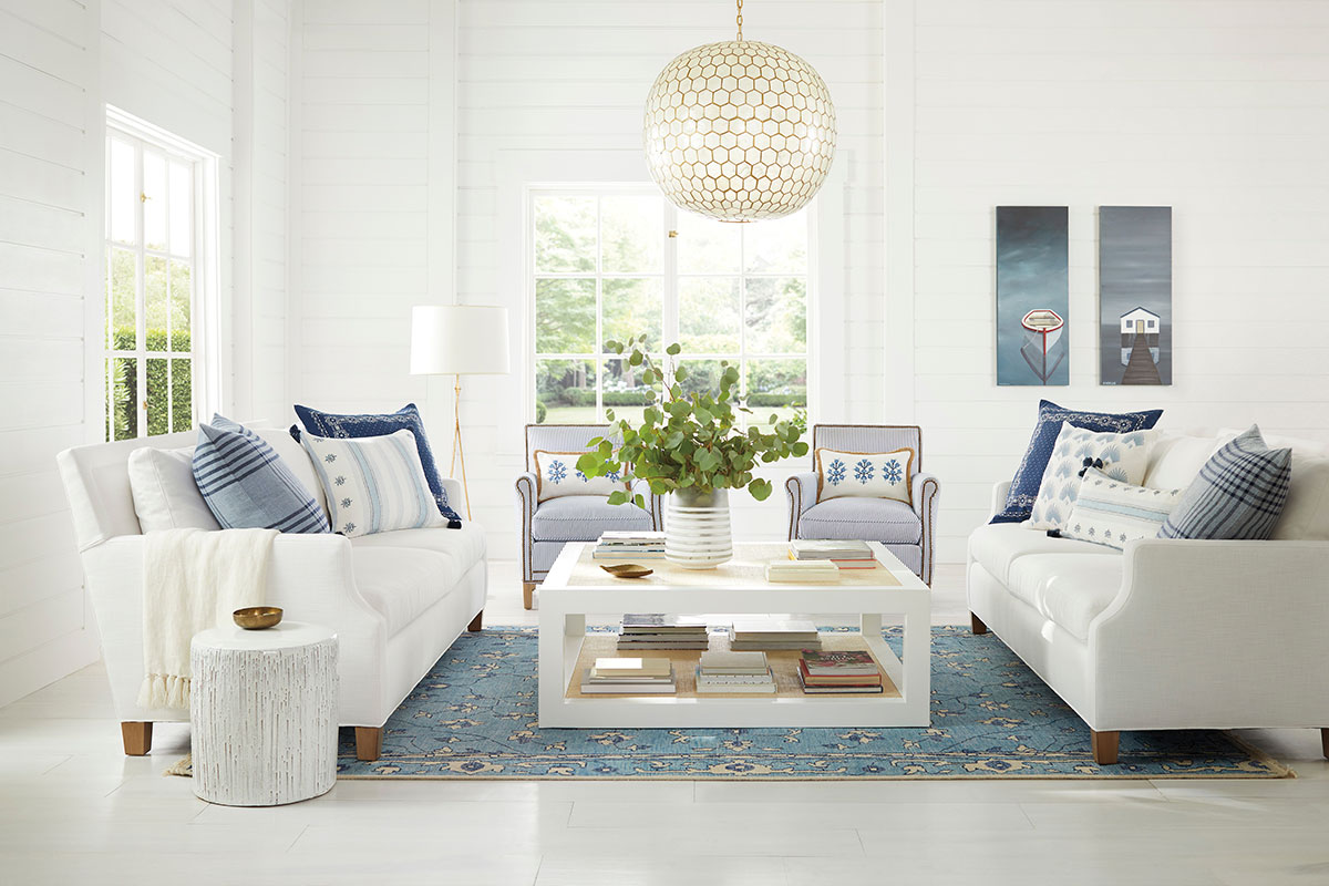 white living room with two couches and table