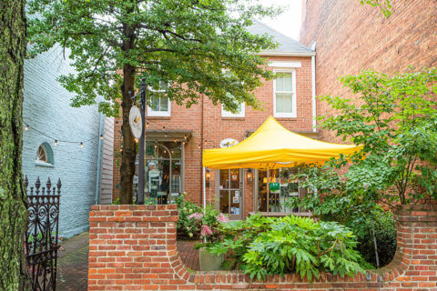 outside courtyard of The Shoe Hive with yellow tent