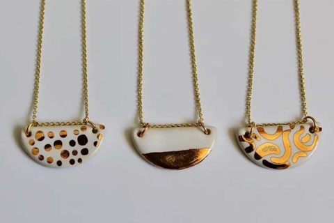 gold and white necklace pendants with gold chains