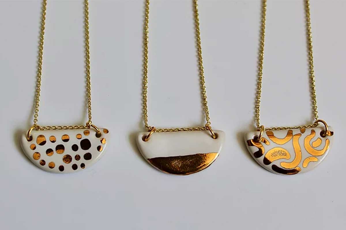 gold and white necklace pendants with gold chains