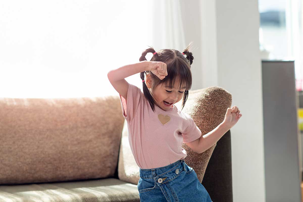 little girl dancing in pink shirt