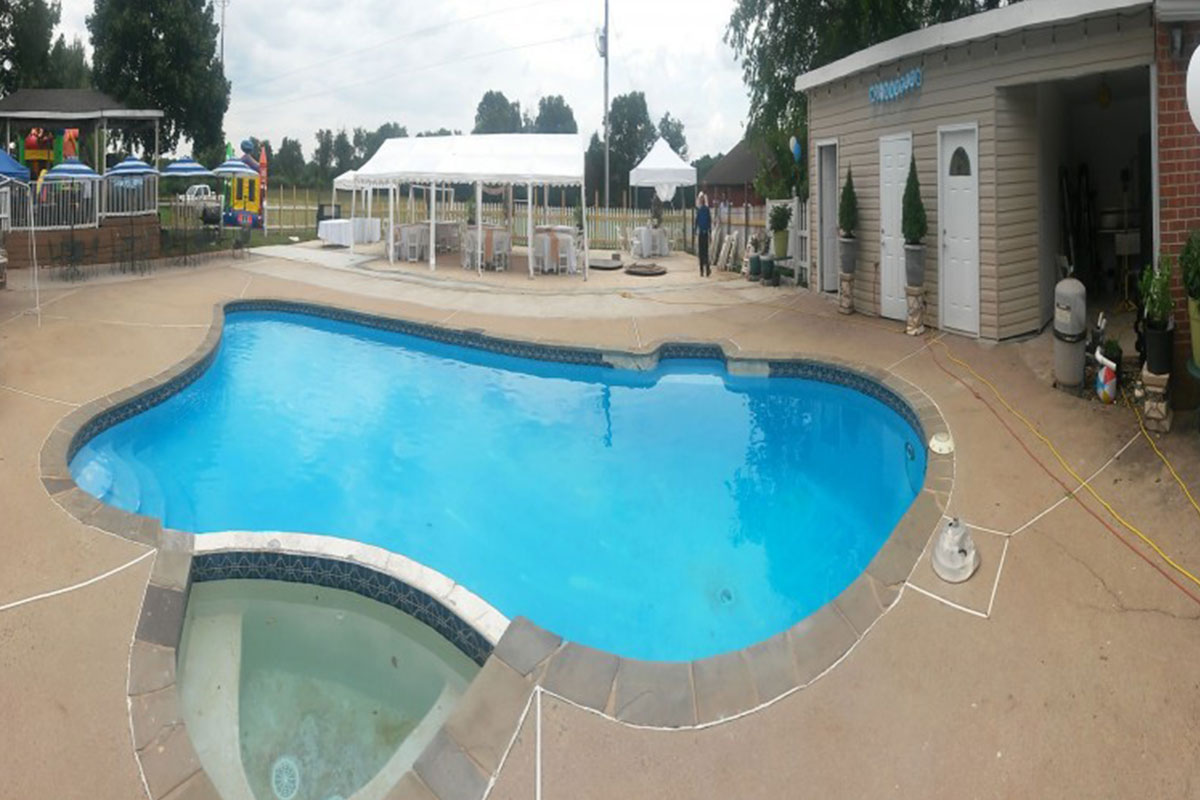 swimming pool with little hot tub and white tent in background