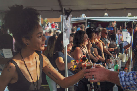 woman handing out beer