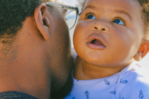 black father holding black baby