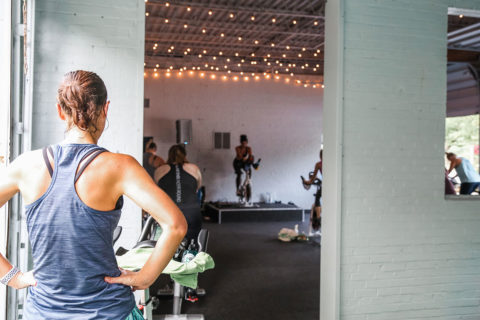 woman looking into cycling studio