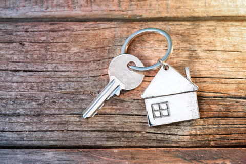 a key on a keychain with house shaped pendant