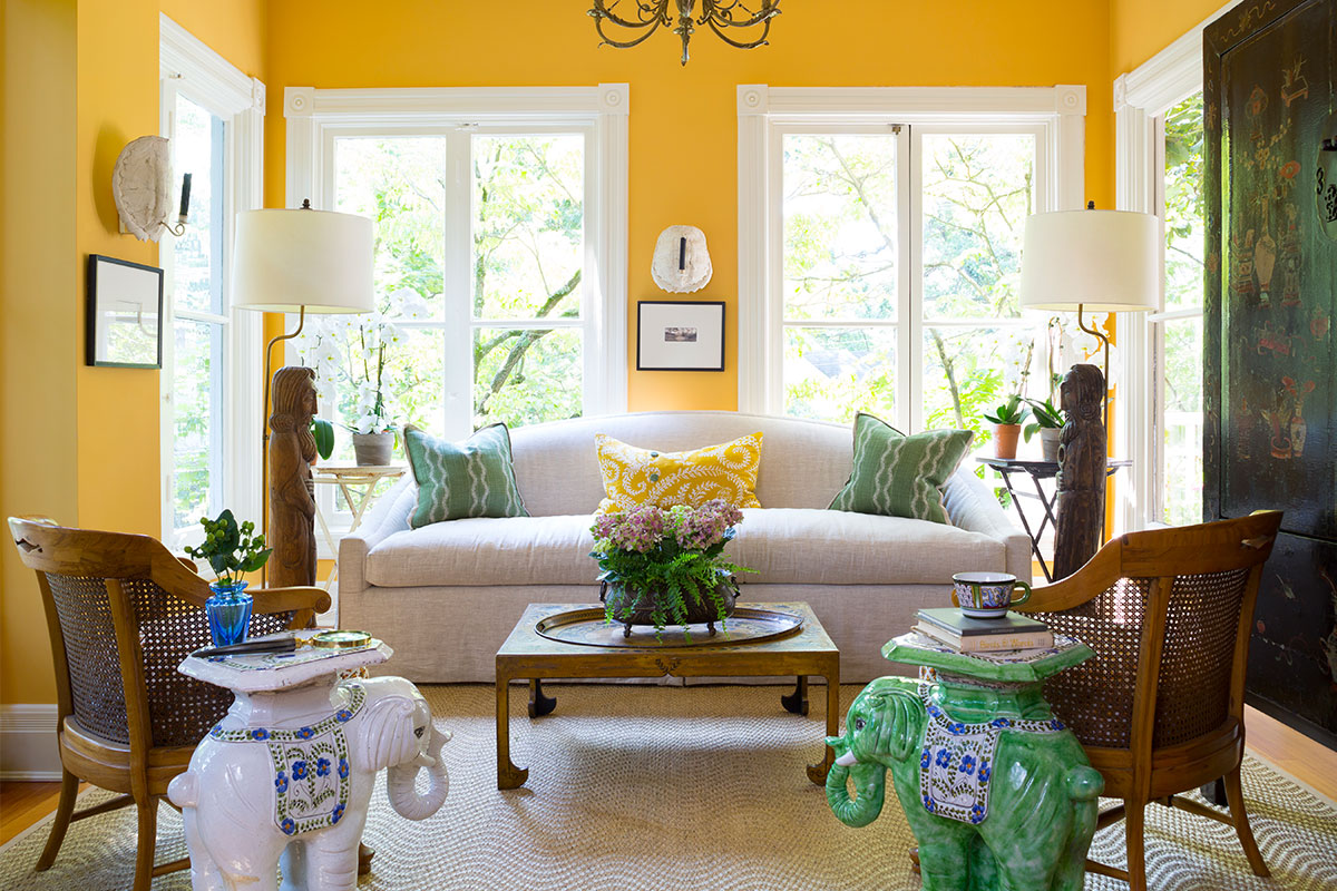 yellow painted sunroom with elephant statues