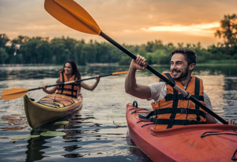 Two people kayaking at sunset