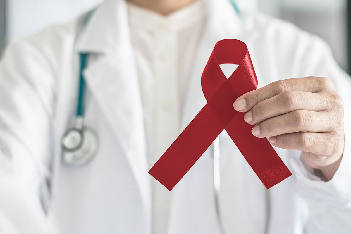 doctor holding red ribbon in hand for multiple meloma awareness