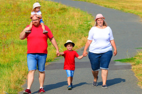 family holding hands walking on trail