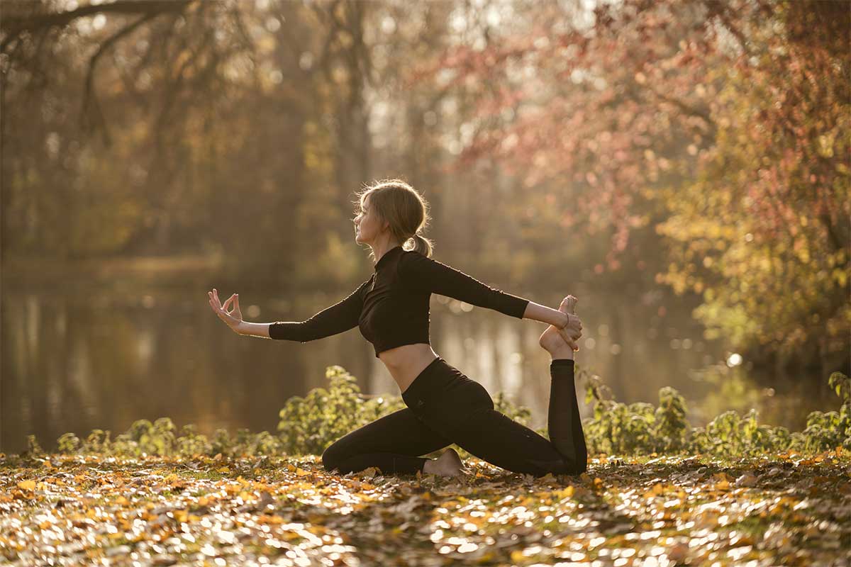woman doing yoga in fall