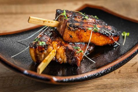 pork belly on stick on plate