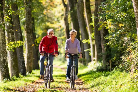 couple riding bikes on trail