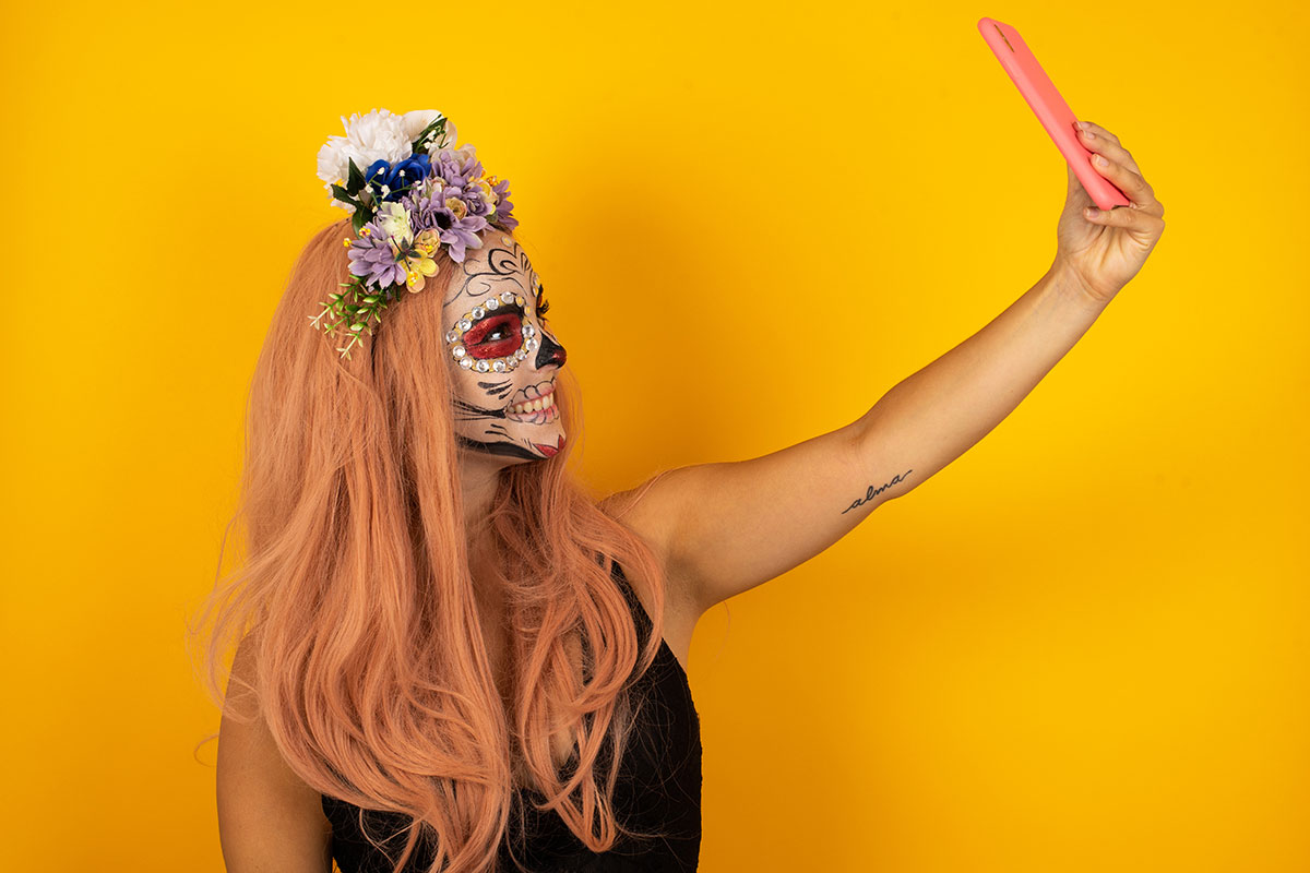 woman in Halloween costume taking selfie