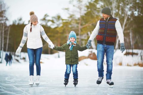 family ice skating outdoors