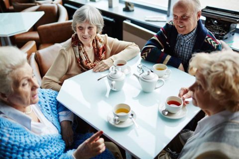Seniors drinking tea around the table