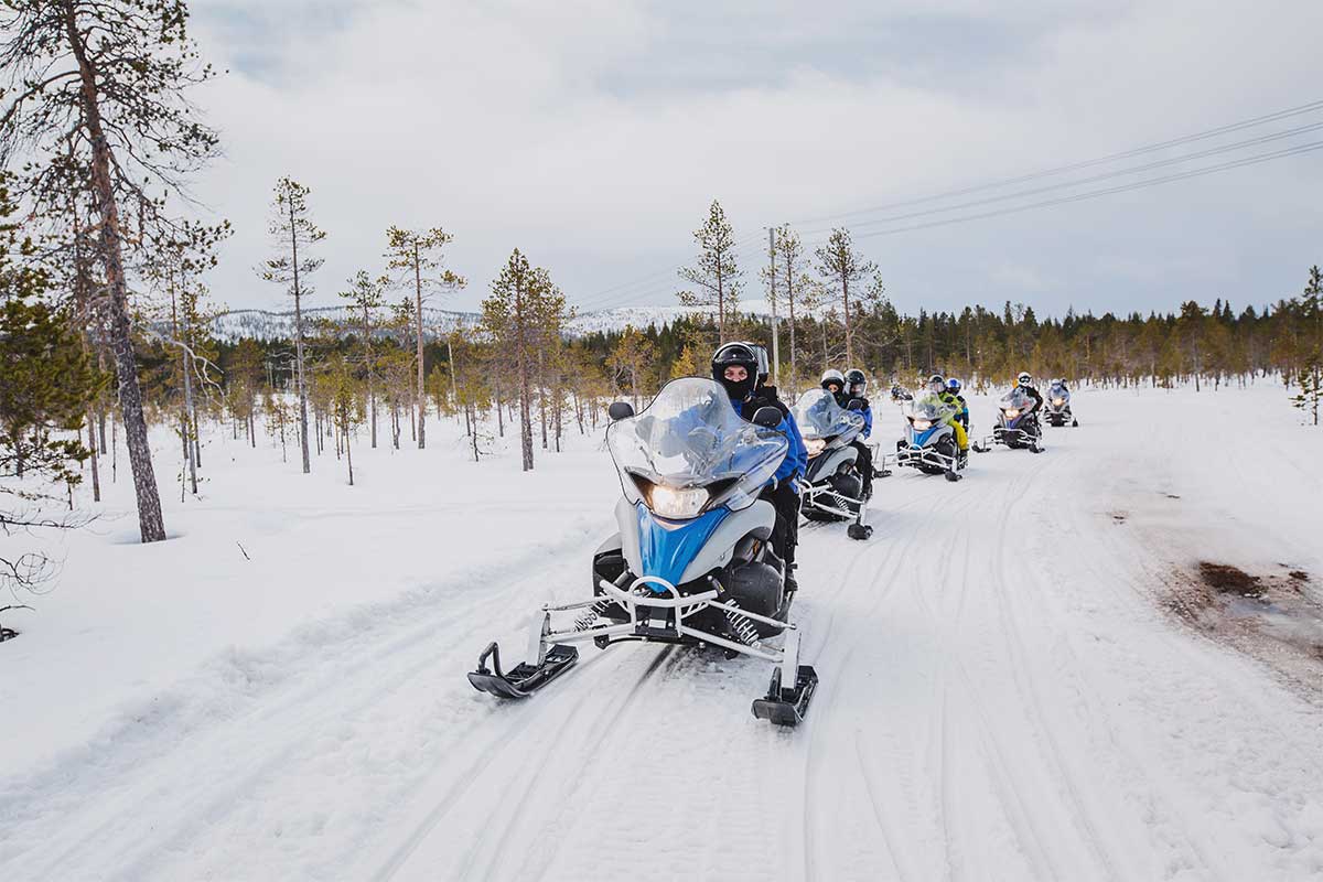 group snowmobiling in snow