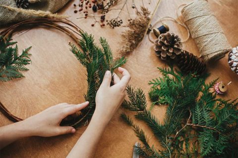 woman making holiday wreath
