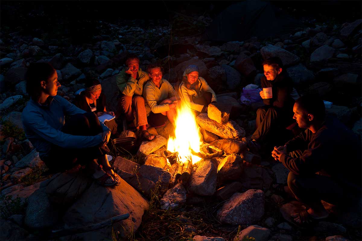 group sitting around campfire