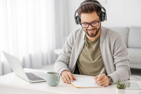 man taking notes at home