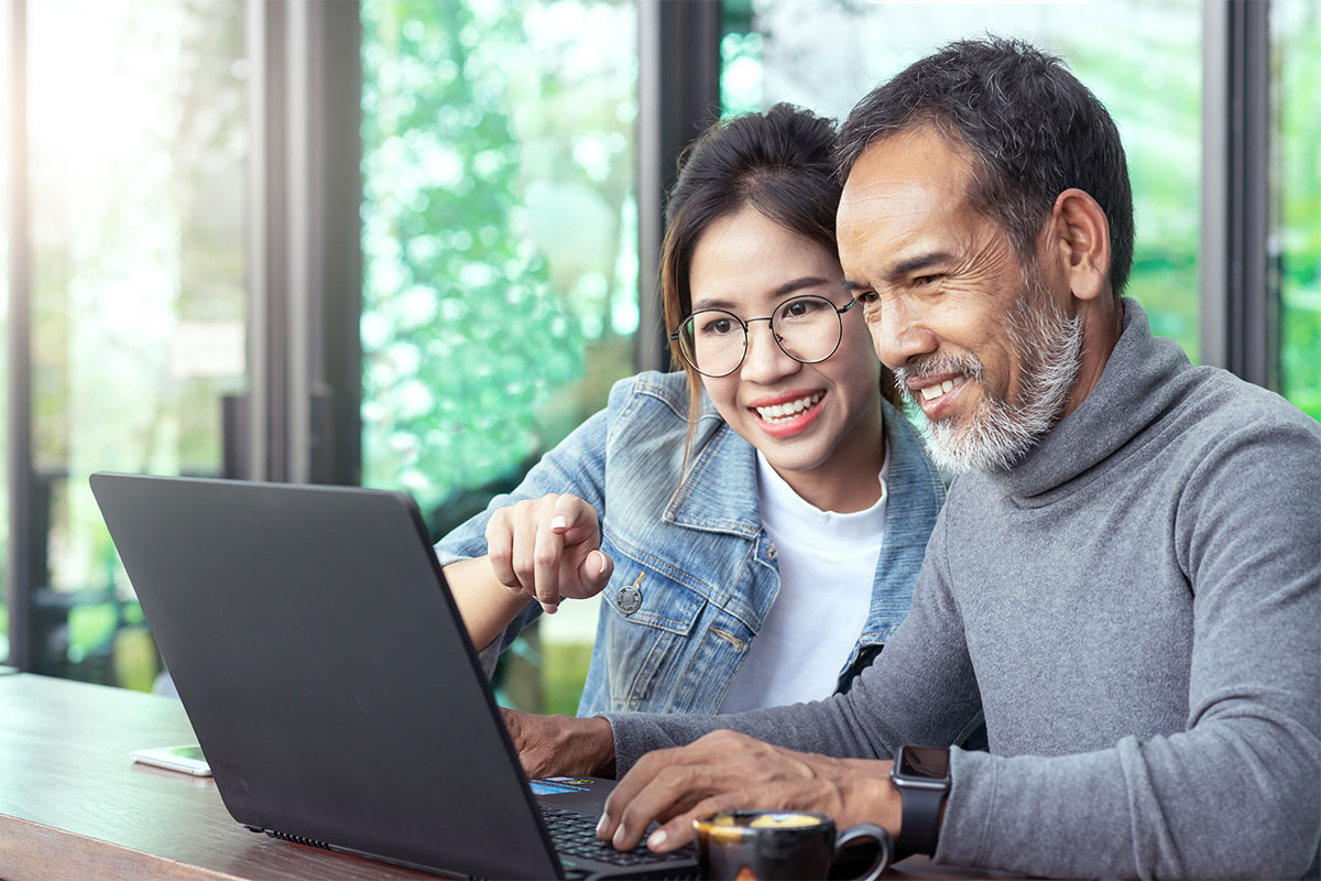 father and daughter looking at computer