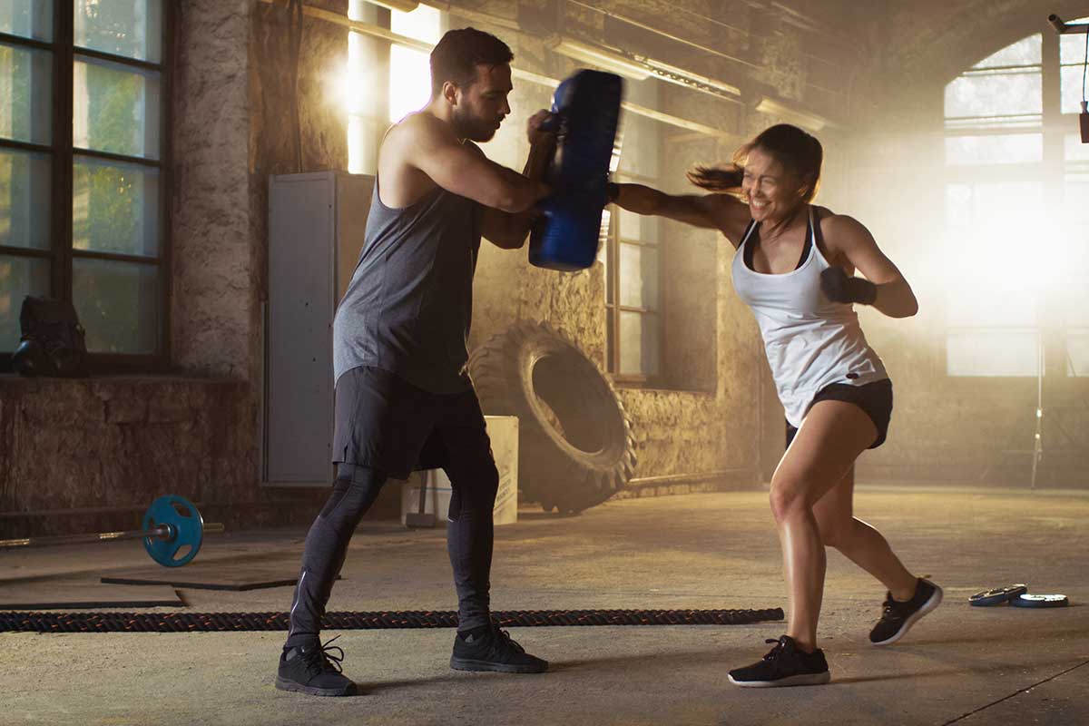 woman boxing with man