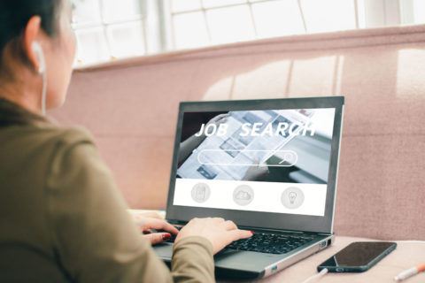 A person searches for job on a laptop