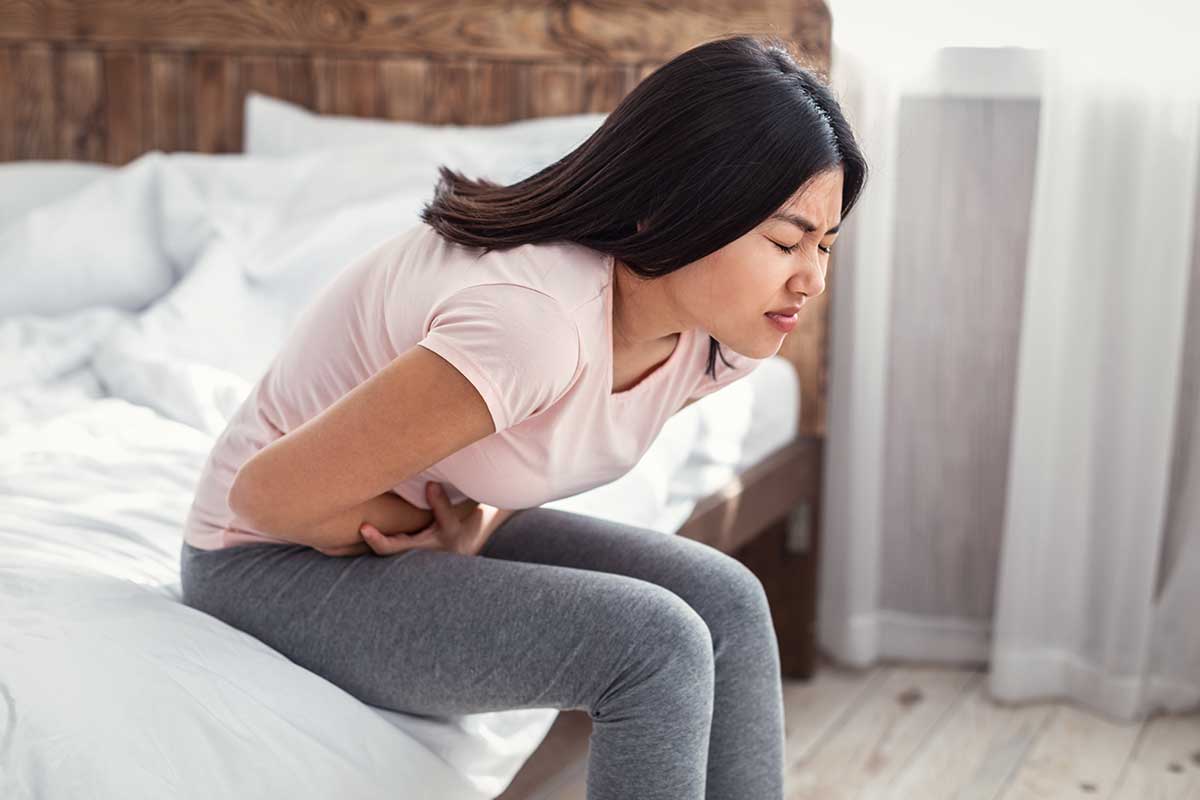 woman bent over in pain