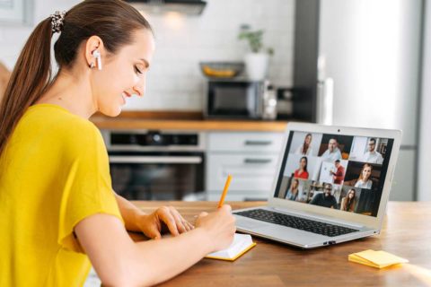 woman taking notes on computer