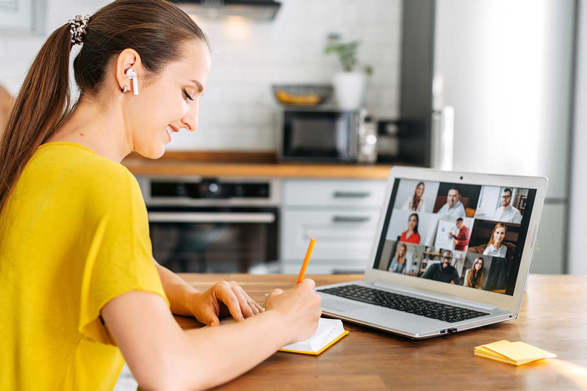woman taking notes on computer