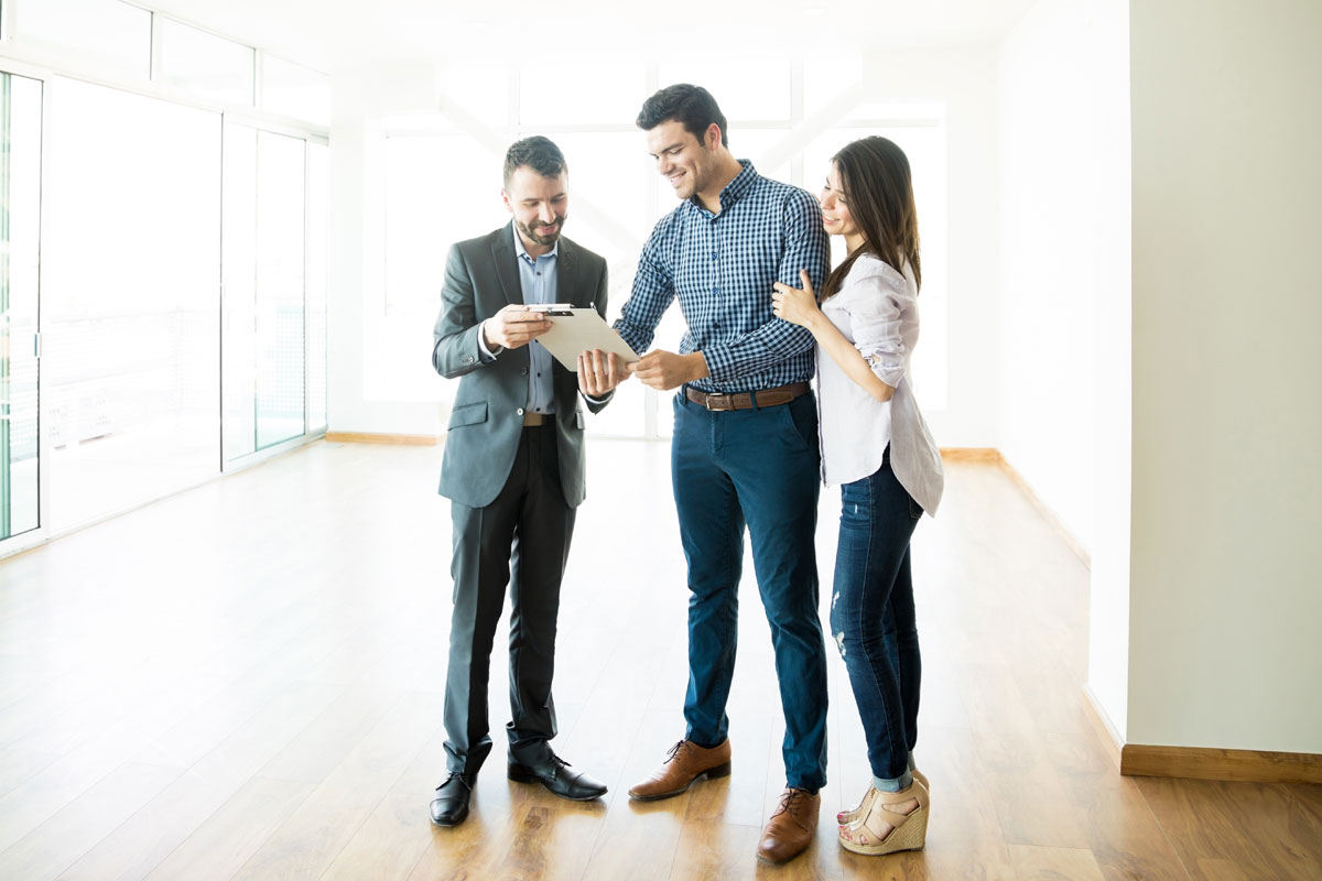 three people looking at clipboard