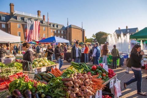 people walking through farmers market