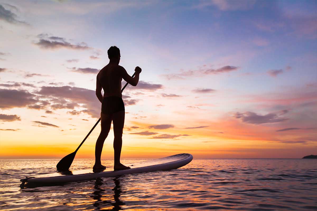 paddleboarding at sunset