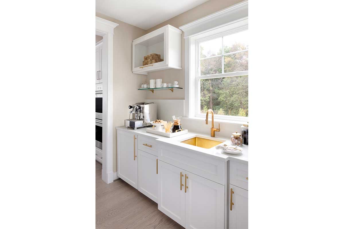 white kitchen cabinents with gold sink