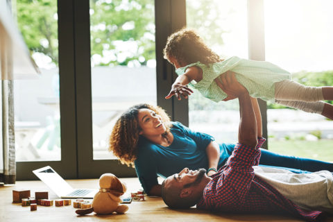 parents lifting up child
