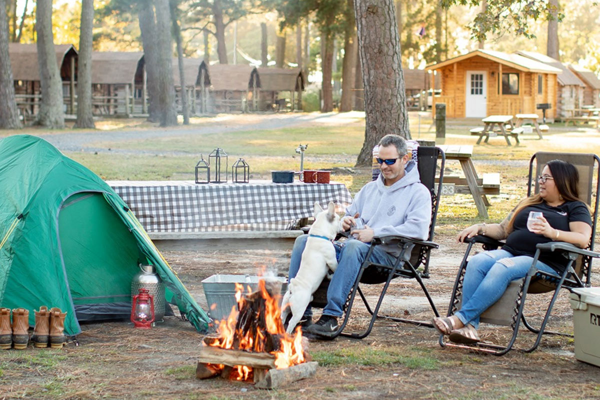 family sitting at camp site