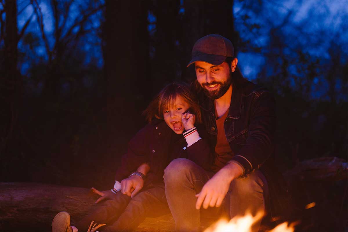 dad and daughter at campfire