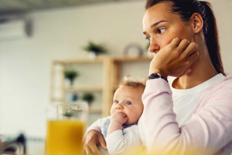 mom holding baby in lap