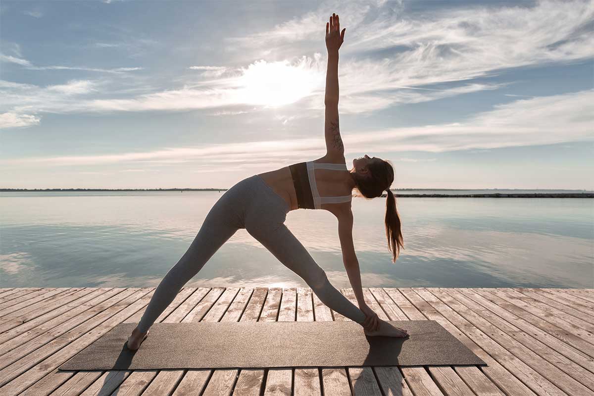 woman doing yoga on dock
