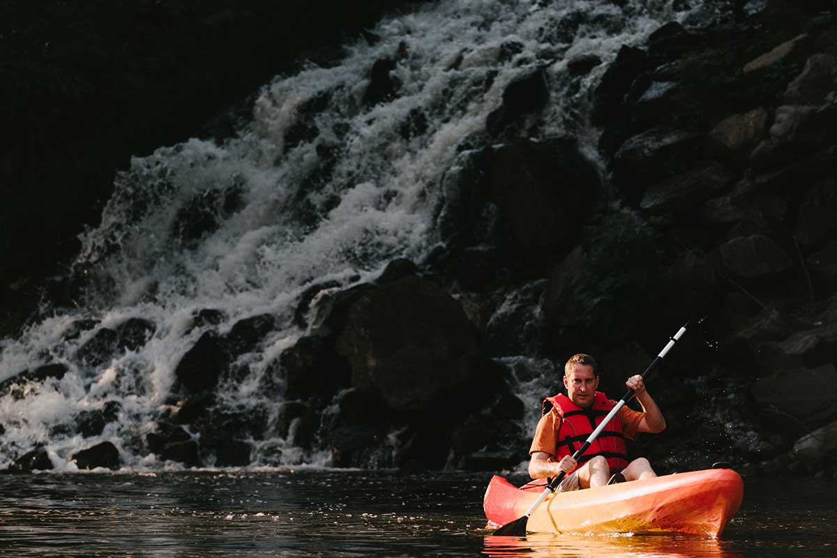 kayaking by waterfall