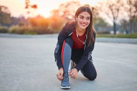 woman tying shoe