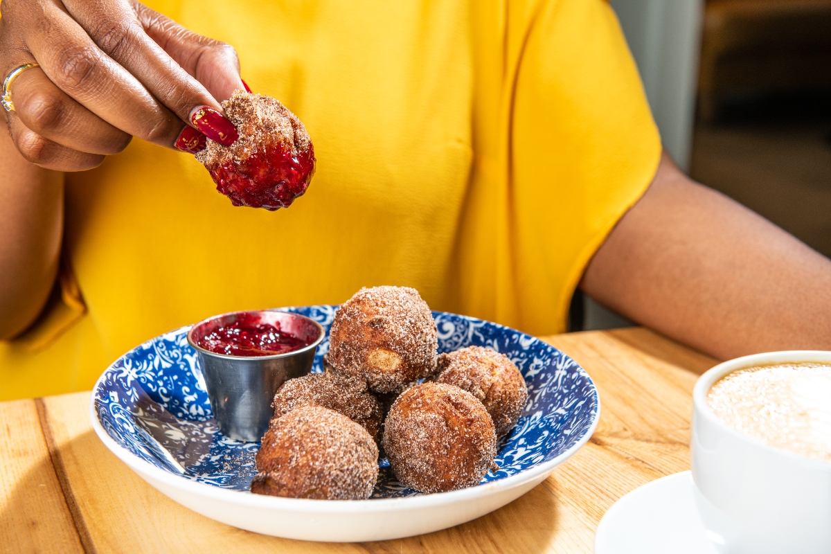 Dip into happiness in the form of dreamy fried-to-order apple doughnuts with warm raspberry jam. 
